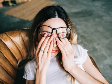Frau mit Brille reibt sich die Augen | © Getty Images/nikkimeel