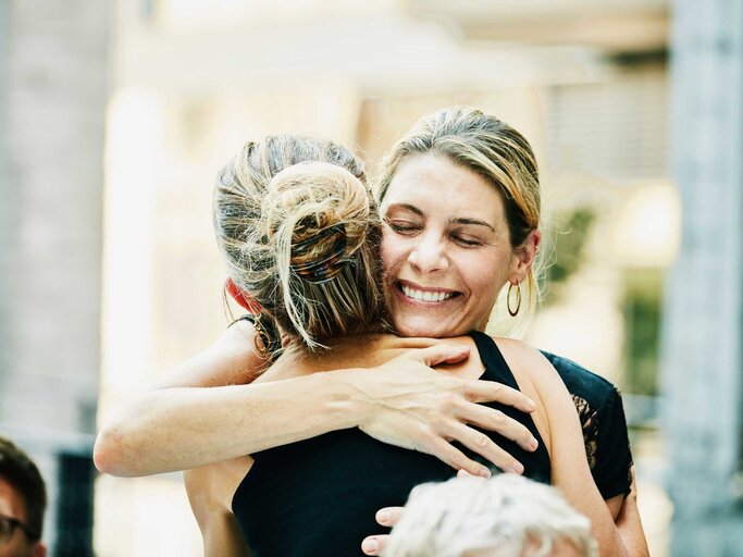 Zwei Frauen umarmen sich freudig | © Getty Images/Thomas Barwick