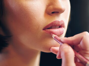 Frau umrahmt Lippen mit Lipliner | © AdobeStock/LIGHTFIELD STUDIOS
