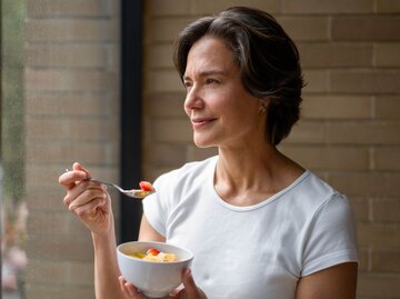 Person isst aus Schüssel vor Fenster | © Getty Images/Hispanolistic