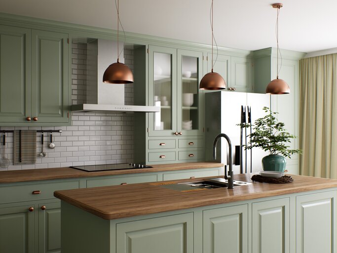 Schöne Küche mit salbeigrünen Möbeln und Kupferlampen | © AdobeStock/sanchopancho