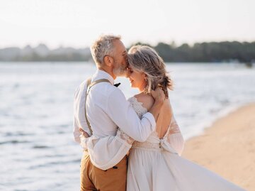 Älteres Ehepaar am Strand umarmt sich verliebt | © Getty Images/ielanum