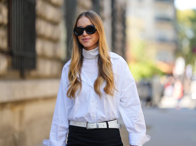 Streetstyle von Pernille Teisbæk in weißer Bluse, unter der sie einen weißen Rollkragenpullover trägt | © Getty Images/Edward Berthelot