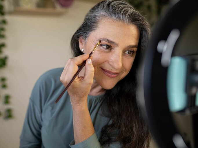 Frau schminkt sich die Augenbrauen | © Getty Images/Westend61