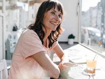 Lachende brünette Frau mit rosa T-Shirt | © Westend61, Getty Images