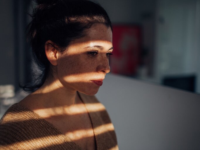Frau mit Schatten im Gesicht. | © istock; AleksandarNakic
