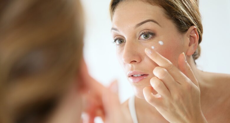 Frau trägt Creme auf  | © AdobeStock/goodluz