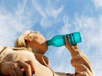 Frau trinkt Wasser nach einem Workout | © Getty Images/rbkomar